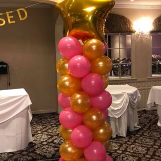 pink and gold balloon column with a gold star topper